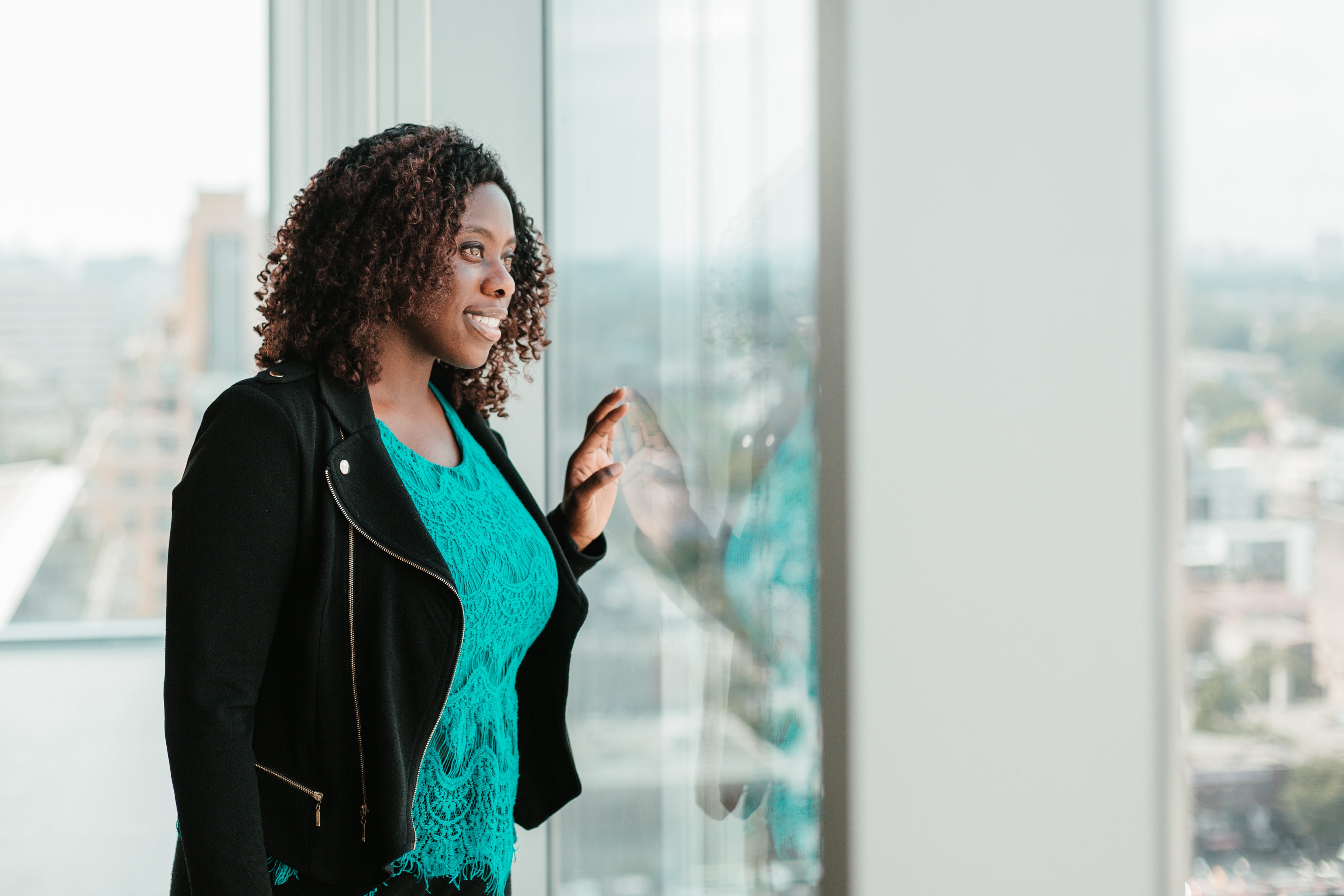 files/happy-woman-looking-out-woman-from-highrise-office.jpg